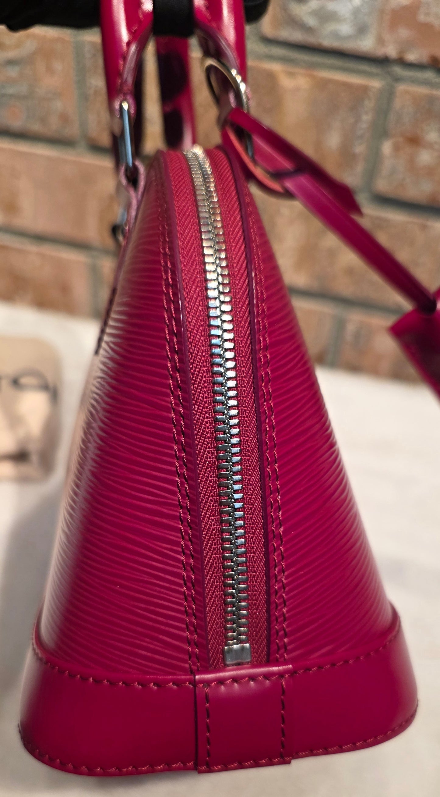 Authentic Louis Vuitton Alma BB Epi Leather in Fuchsia